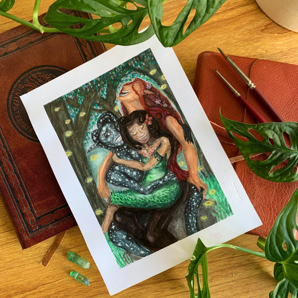 An art print of three laughing magic-wielders. The print lies on a background of old books, with monstera leaves in the foreground.